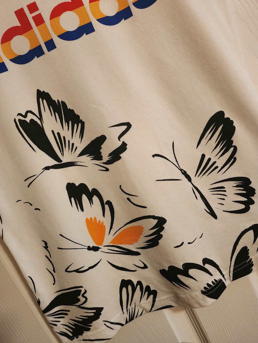 adidas White Tee with Multicolor Logo and Black Butterfly Print - Picture 2 of 5